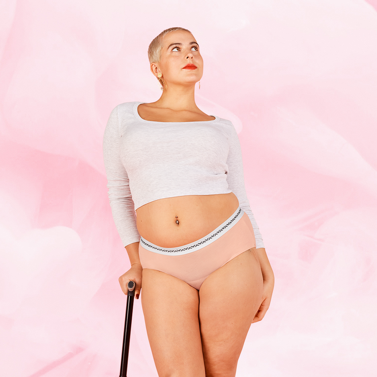 Woman modeling ComfortFit Essentials Hipster Logo Waistband Heavy period pants, showcasing the design's fit and functionality for reliable, long-lasting protection.