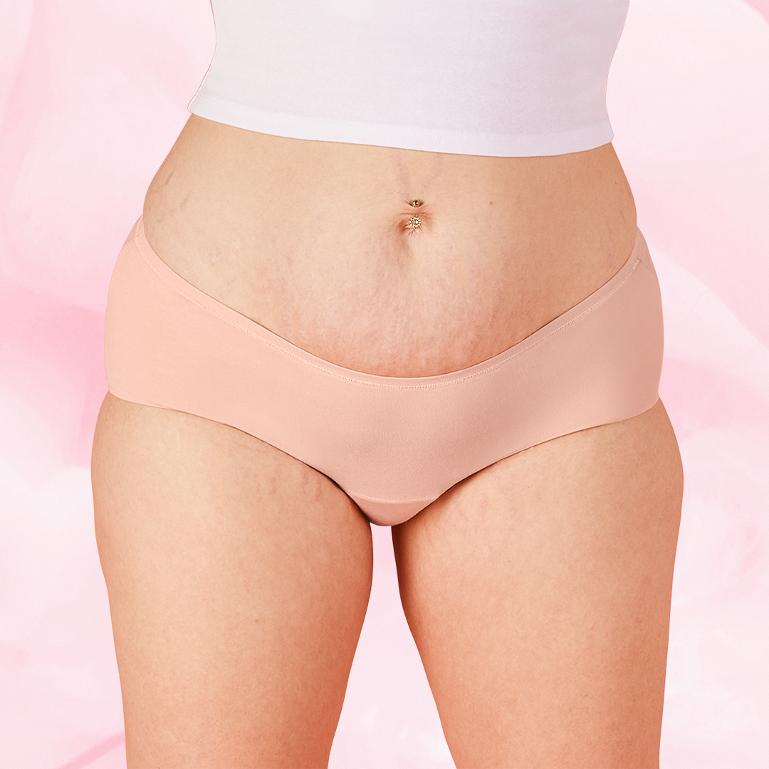 ComfortFit Essentials Hipster Moderate period pants, shown close-up on a woman's belly, highlighting the snug fit and discreet design for reliable protection.